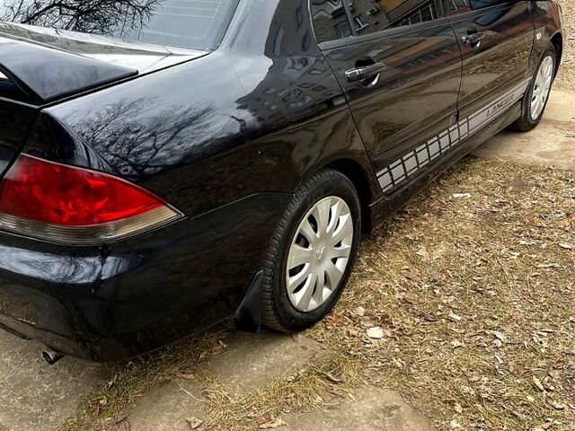 Чорний Міцубісі Lancer, об'ємом двигуна 1.6 л та пробігом 222 тис. км за 4000 $, фото 3 на Automoto.ua