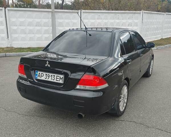 Чорний Міцубісі Lancer, об'ємом двигуна 1.58 л та пробігом 190 тис. км за 3750 $, фото 6 на Automoto.ua