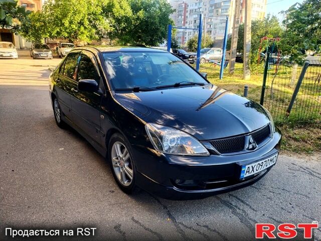 Черный Мицубиси Лансер, объемом двигателя 2 л и пробегом 200 тыс. км за 4450 $, фото 1 на Automoto.ua