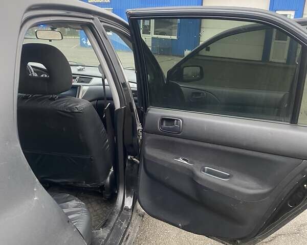 Черный Мицубиси Лансер, объемом двигателя 1.58 л и пробегом 263 тыс. км за 4000 $, фото 30 на Automoto.ua