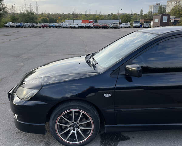 Чорний Міцубісі Lancer, об'ємом двигуна 2 л та пробігом 280 тис. км за 4600 $, фото 11 на Automoto.ua