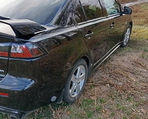 Черный Мицубиси Лансер, объемом двигателя 2 л и пробегом 200 тыс. км за 5900 $, фото 1 на Automoto.ua