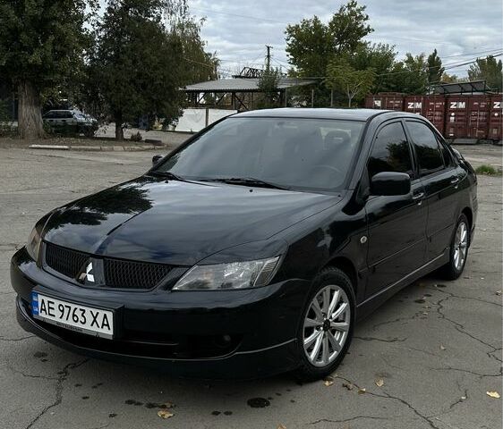 Чорний Міцубісі Lancer, об'ємом двигуна 2 л та пробігом 143 тис. км за 5400 $, фото 1 на Automoto.ua