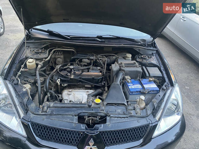 Чорний Міцубісі Lancer, об'ємом двигуна 1.58 л та пробігом 224 тис. км за 3900 $, фото 7 на Automoto.ua