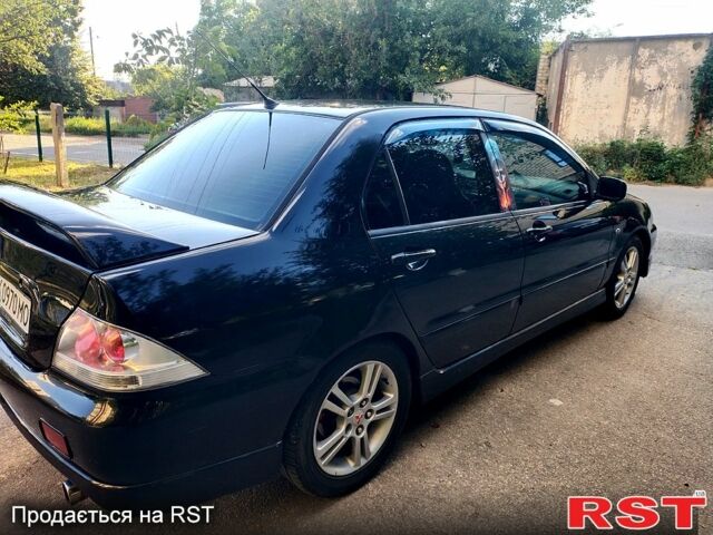 Черный Мицубиси Лансер, объемом двигателя 2 л и пробегом 200 тыс. км за 4450 $, фото 6 на Automoto.ua