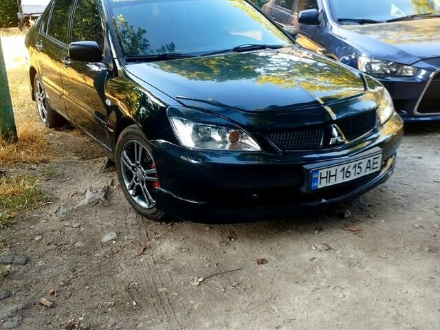 Черный Мицубиси Лансер, объемом двигателя 2 л и пробегом 168 тыс. км за 3800 $, фото 3 на Automoto.ua
