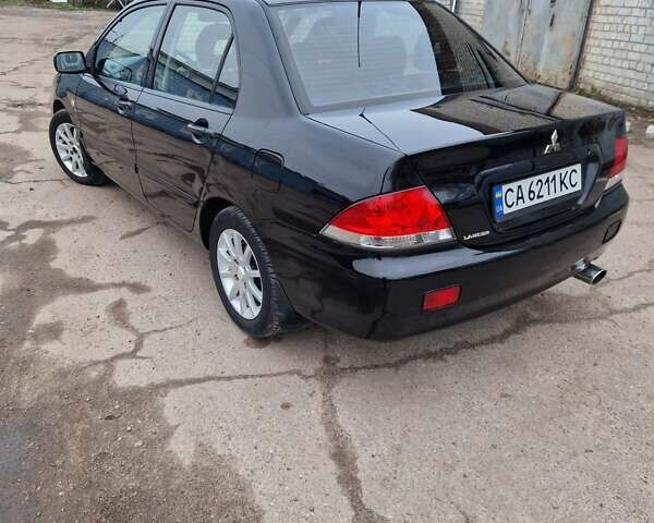 Чорний Міцубісі Lancer, об'ємом двигуна 1.6 л та пробігом 273 тис. км за 3999 $, фото 9 на Automoto.ua