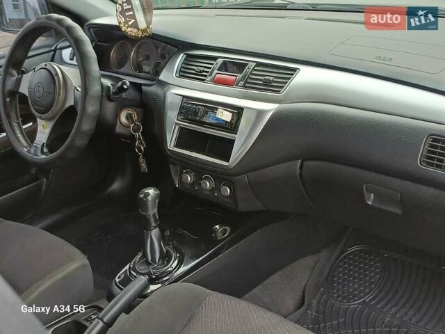 Черный Мицубиси Лансер, объемом двигателя 2 л и пробегом 286 тыс. км за 4000 $, фото 14 на Automoto.ua