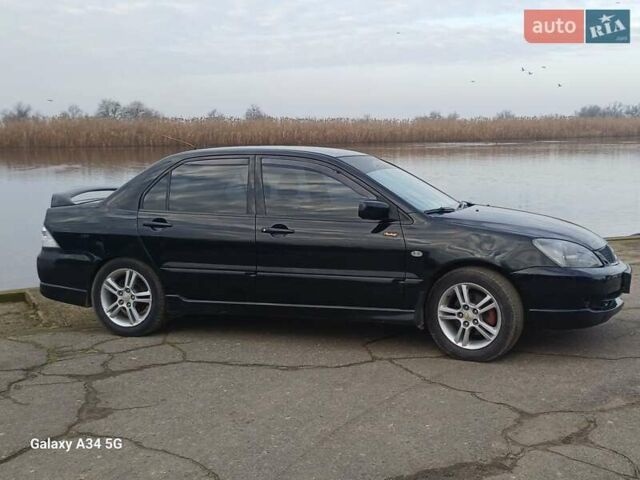 Черный Мицубиси Лансер, объемом двигателя 2 л и пробегом 286 тыс. км за 4000 $, фото 4 на Automoto.ua