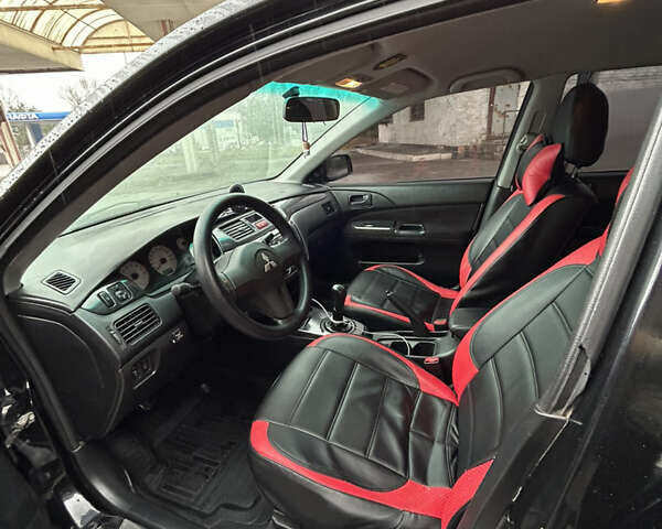 Черный Мицубиси Лансер, объемом двигателя 1.58 л и пробегом 254 тыс. км за 5000 $, фото 15 на Automoto.ua