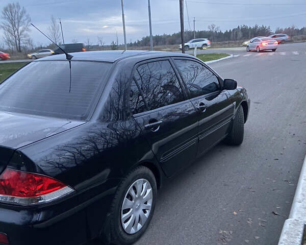 Черный Мицубиси Лансер, объемом двигателя 1.58 л и пробегом 213 тыс. км за 4900 $, фото 2 на Automoto.ua