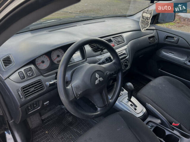 Чорний Міцубісі Lancer, об'ємом двигуна 1.58 л та пробігом 185 тис. км за 3750 $, фото 11 на Automoto.ua