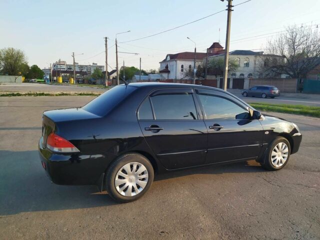 Черный Мицубиси Лансер, объемом двигателя 1.6 л и пробегом 32 тыс. км за 9000 $, фото 13 на Automoto.ua