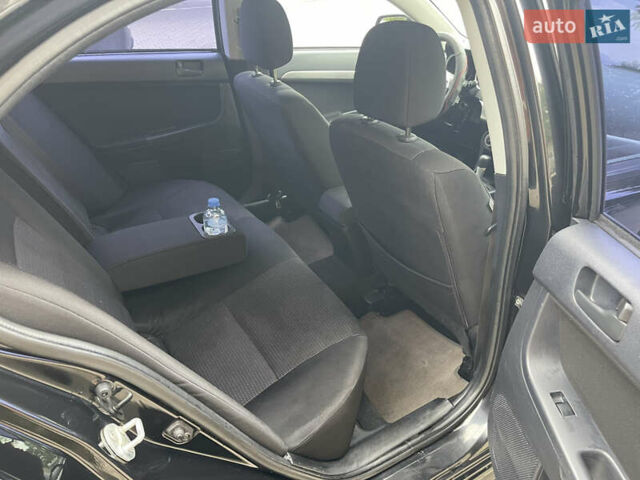 Черный Мицубиси Лансер, объемом двигателя 2 л и пробегом 200 тыс. км за 6199 $, фото 8 на Automoto.ua