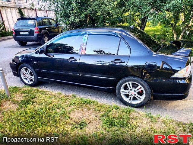 Черный Мицубиси Лансер, объемом двигателя 2 л и пробегом 200 тыс. км за 4450 $, фото 4 на Automoto.ua