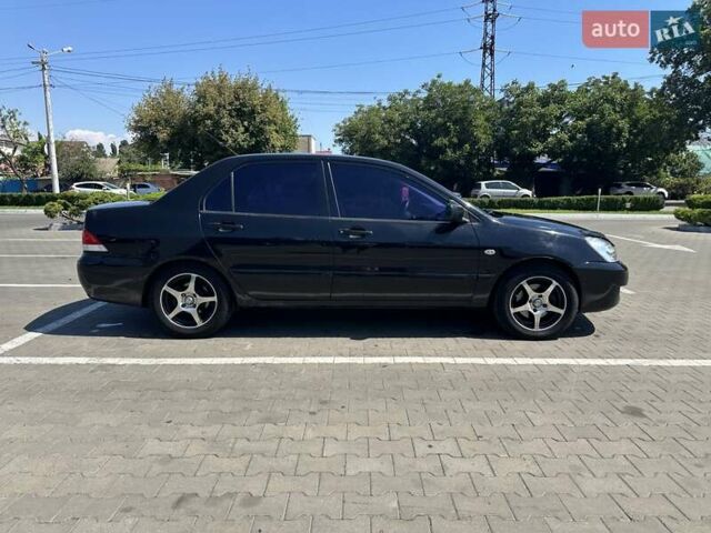 Черный Мицубиси Лансер, объемом двигателя 1.58 л и пробегом 260 тыс. км за 3600 $, фото 7 на Automoto.ua