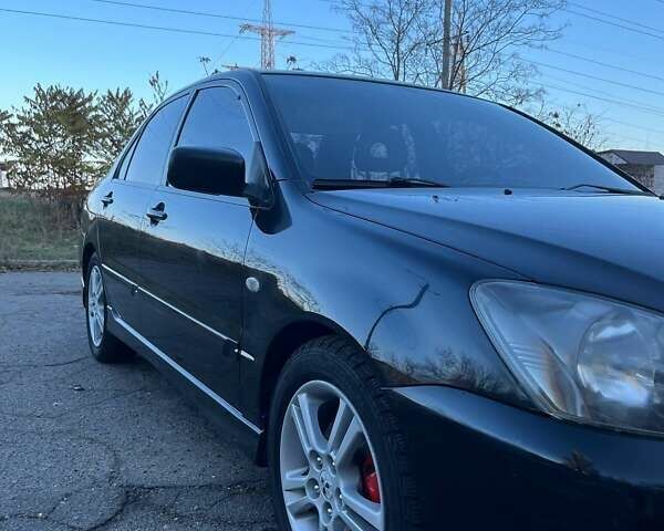 Черный Мицубиси Лансер, объемом двигателя 2 л и пробегом 280 тыс. км за 5400 $, фото 2 на Automoto.ua