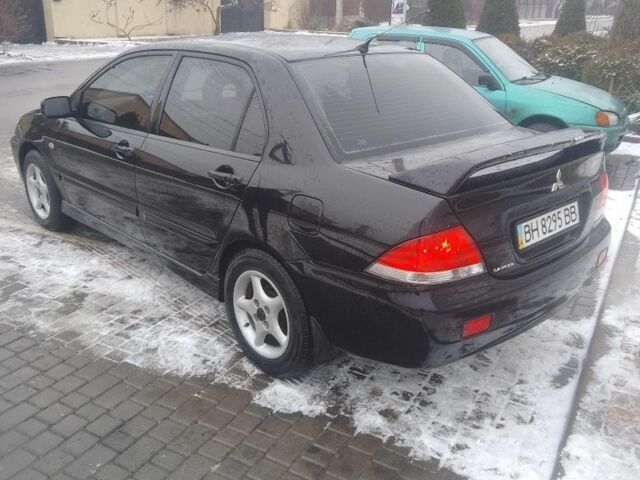 Черный Мицубиси Лансер, объемом двигателя 1 л и пробегом 2 тыс. км за 2700 $, фото 2 на Automoto.ua