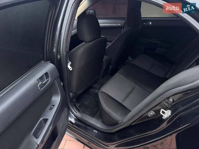 Черный Мицубиси Лансер, объемом двигателя 2 л и пробегом 217 тыс. км за 5500 $, фото 10 на Automoto.ua