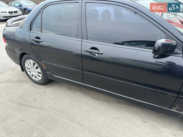 Черный Мицубиси Лансер, объемом двигателя 1.58 л и пробегом 290 тыс. км за 3000 $, фото 3 на Automoto.ua