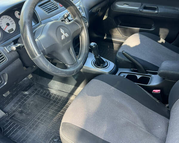 Чорний Міцубісі Lancer, об'ємом двигуна 1.58 л та пробігом 175 тис. км за 5200 $, фото 7 на Automoto.ua
