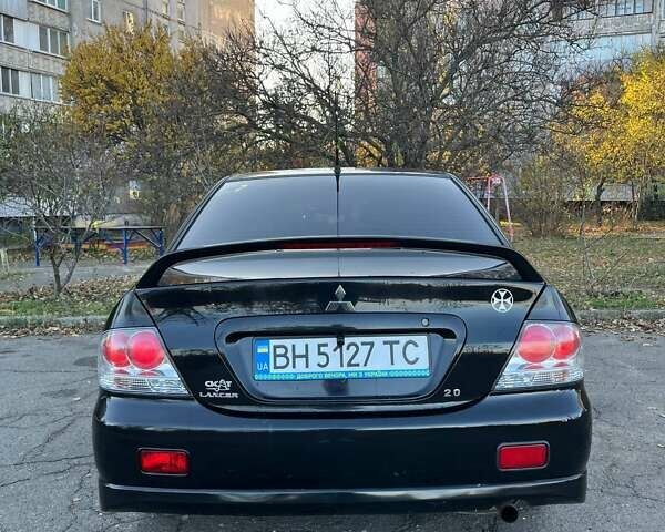 Черный Мицубиси Лансер, объемом двигателя 2 л и пробегом 280 тыс. км за 5400 $, фото 4 на Automoto.ua