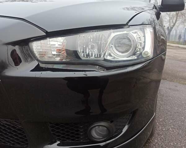 Черный Мицубиси Лансер, объемом двигателя 2 л и пробегом 195 тыс. км за 7899 $, фото 26 на Automoto.ua