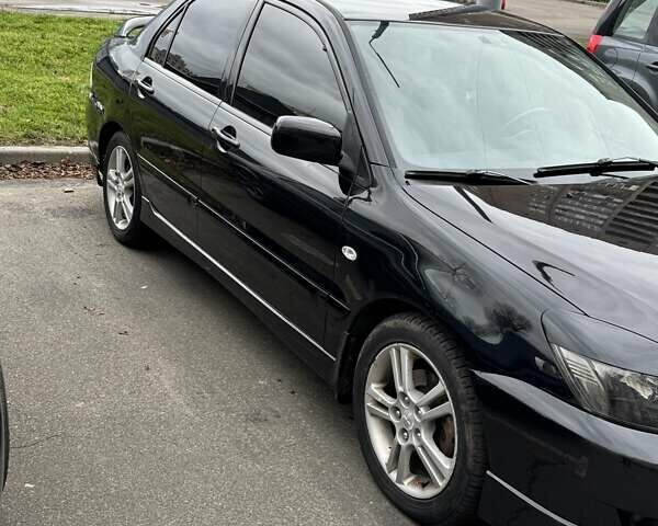 Черный Мицубиси Лансер, объемом двигателя 2 л и пробегом 219 тыс. км за 4400 $, фото 8 на Automoto.ua