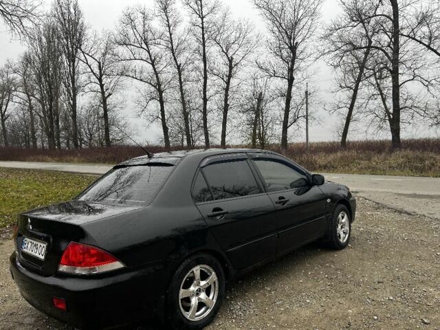 Черный Мицубиси Лансер, объемом двигателя 1.6 л и пробегом 272 тыс. км за 2800 $, фото 4 на Automoto.ua