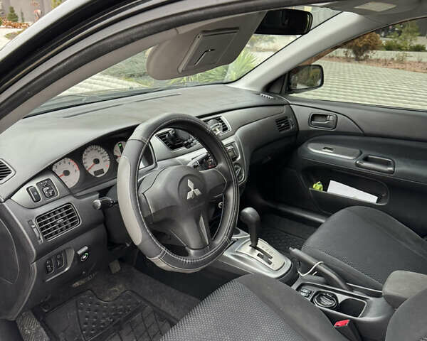 Черный Мицубиси Лансер, объемом двигателя 1.6 л и пробегом 240 тыс. км за 5200 $, фото 4 на Automoto.ua