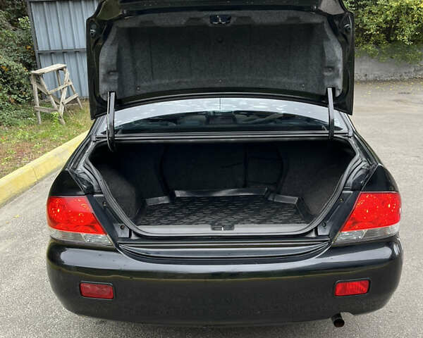 Чорний Міцубісі Lancer, об'ємом двигуна 1.58 л та пробігом 192 тис. км за 4500 $, фото 19 на Automoto.ua