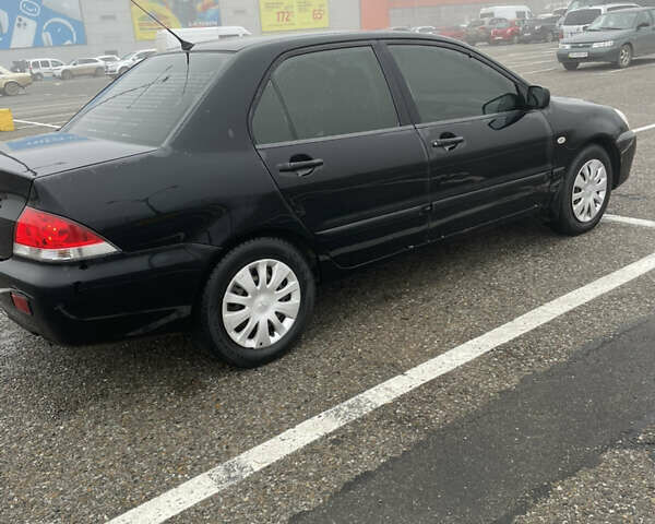 Черный Мицубиси Лансер, объемом двигателя 1.58 л и пробегом 214 тыс. км за 4400 $, фото 12 на Automoto.ua