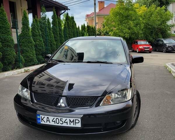 Чорний Міцубісі Lancer, об'ємом двигуна 1.58 л та пробігом 334 тис. км за 4750 $, фото 1 на Automoto.ua