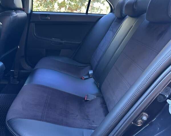 Черный Мицубиси Лансер, объемом двигателя 2 л и пробегом 230 тыс. км за 7000 $, фото 8 на Automoto.ua