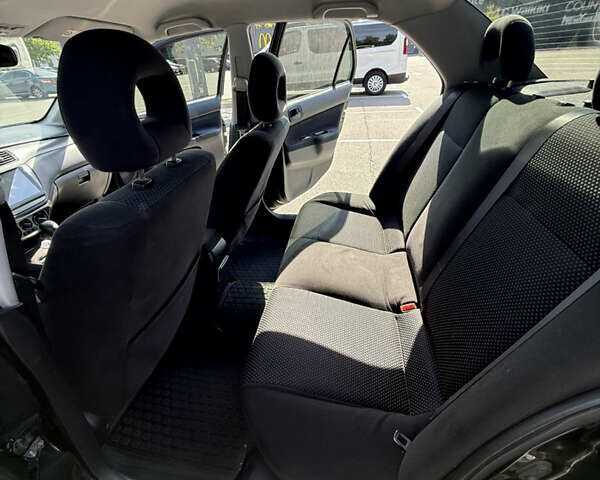 Черный Мицубиси Лансер, объемом двигателя 1.6 л и пробегом 321 тыс. км за 5000 $, фото 23 на Automoto.ua