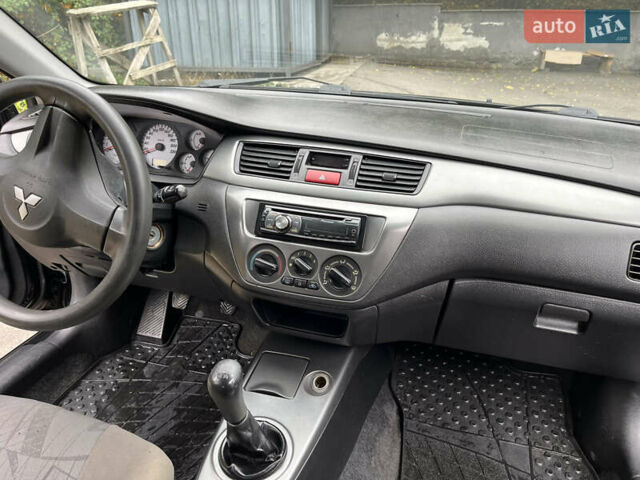 Чорний Міцубісі Lancer, об'ємом двигуна 1.58 л та пробігом 192 тис. км за 4500 $, фото 12 на Automoto.ua