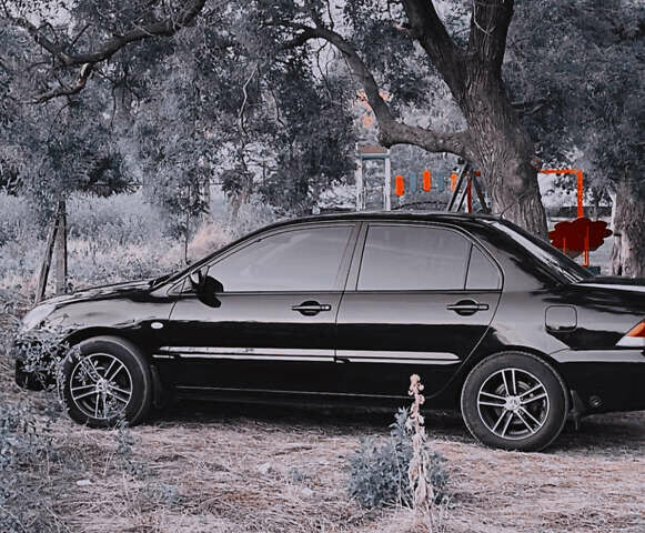 Черный Мицубиси Лансер, объемом двигателя 1.58 л и пробегом 211 тыс. км за 5500 $, фото 5 на Automoto.ua