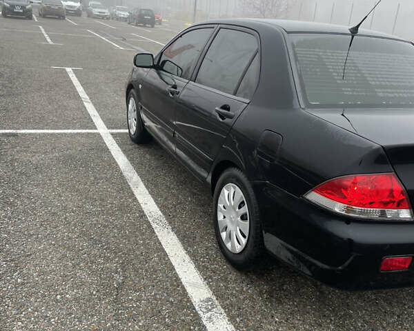 Черный Мицубиси Лансер, объемом двигателя 1.58 л и пробегом 214 тыс. км за 4400 $, фото 11 на Automoto.ua