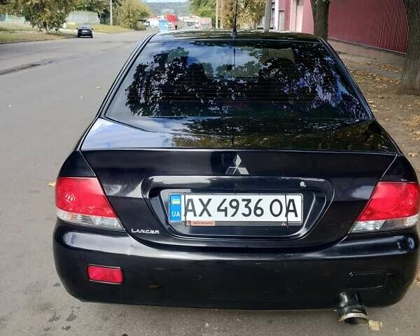 Чорний Міцубісі Lancer, об'ємом двигуна 1.58 л та пробігом 323 тис. км за 4500 $, фото 10 на Automoto.ua