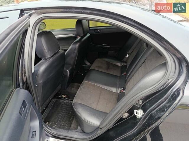 Черный Мицубиси Лансер, объемом двигателя 2 л и пробегом 200 тыс. км за 5100 $, фото 11 на Automoto.ua