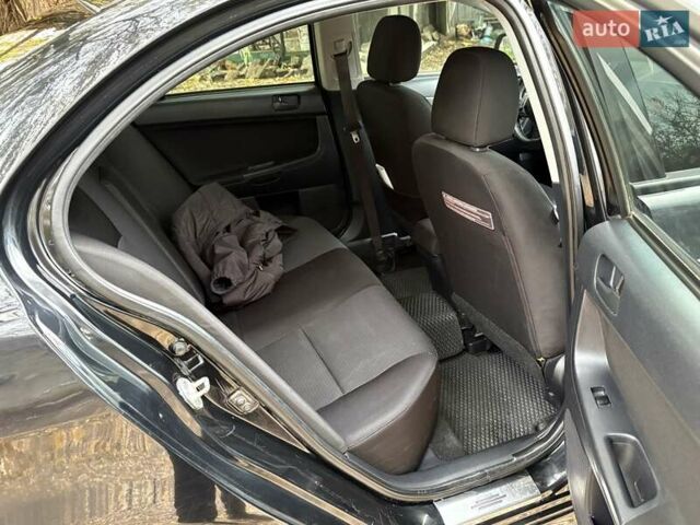 Черный Мицубиси Лансер, объемом двигателя 2 л и пробегом 260 тыс. км за 6100 $, фото 13 на Automoto.ua