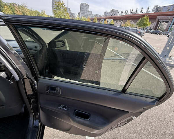 Черный Мицубиси Лансер, объемом двигателя 1.6 л и пробегом 321 тыс. км за 5000 $, фото 32 на Automoto.ua