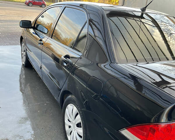 Черный Мицубиси Лансер, объемом двигателя 1.59 л и пробегом 348 тыс. км за 4200 $, фото 1 на Automoto.ua