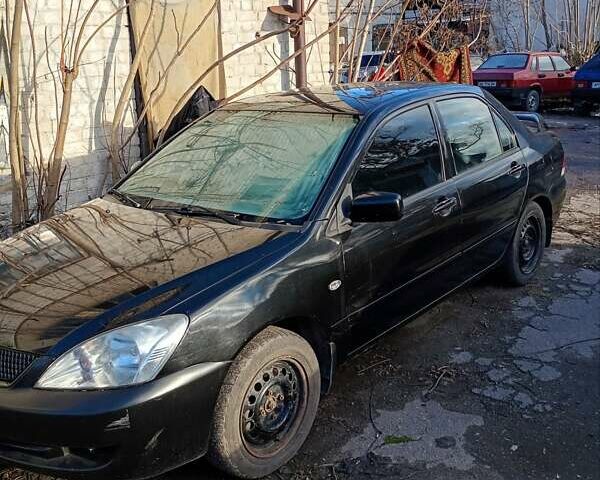 Черный Мицубиси Лансер, объемом двигателя 1.6 л и пробегом 140 тыс. км за 2500 $, фото 2 на Automoto.ua