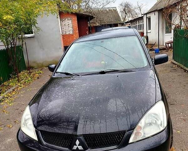 Черный Мицубиси Лансер, объемом двигателя 1.6 л и пробегом 126 тыс. км за 4500 $, фото 2 на Automoto.ua