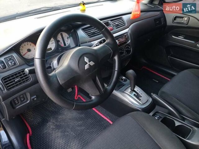 Чорний Міцубісі Lancer, об'ємом двигуна 1.58 л та пробігом 286 тис. км за 4950 $, фото 5 на Automoto.ua