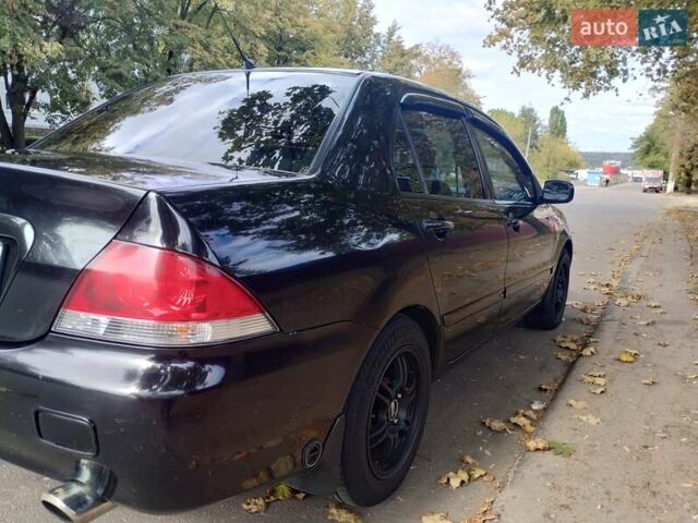 Чорний Міцубісі Lancer, об'ємом двигуна 1.58 л та пробігом 323 тис. км за 4500 $, фото 9 на Automoto.ua