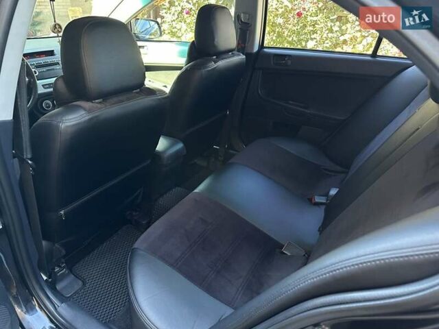 Черный Мицубиси Лансер, объемом двигателя 2 л и пробегом 230 тыс. км за 7000 $, фото 4 на Automoto.ua
