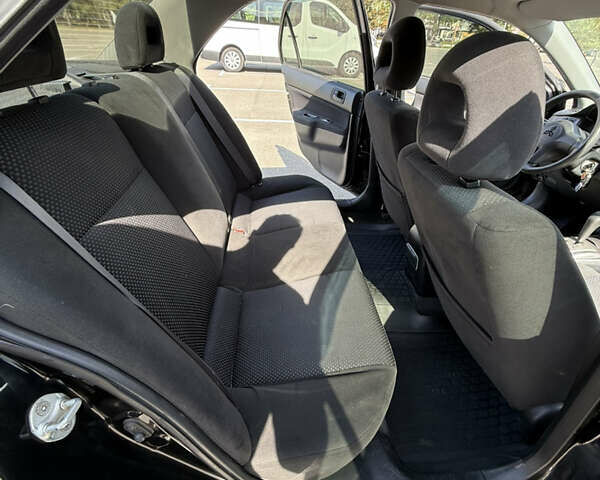 Черный Мицубиси Лансер, объемом двигателя 1.6 л и пробегом 321 тыс. км за 5000 $, фото 24 на Automoto.ua