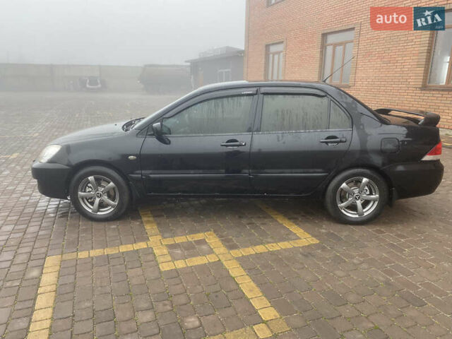 Черный Мицубиси Лансер, объемом двигателя 1.58 л и пробегом 211 тыс. км за 6333 $, фото 10 на Automoto.ua